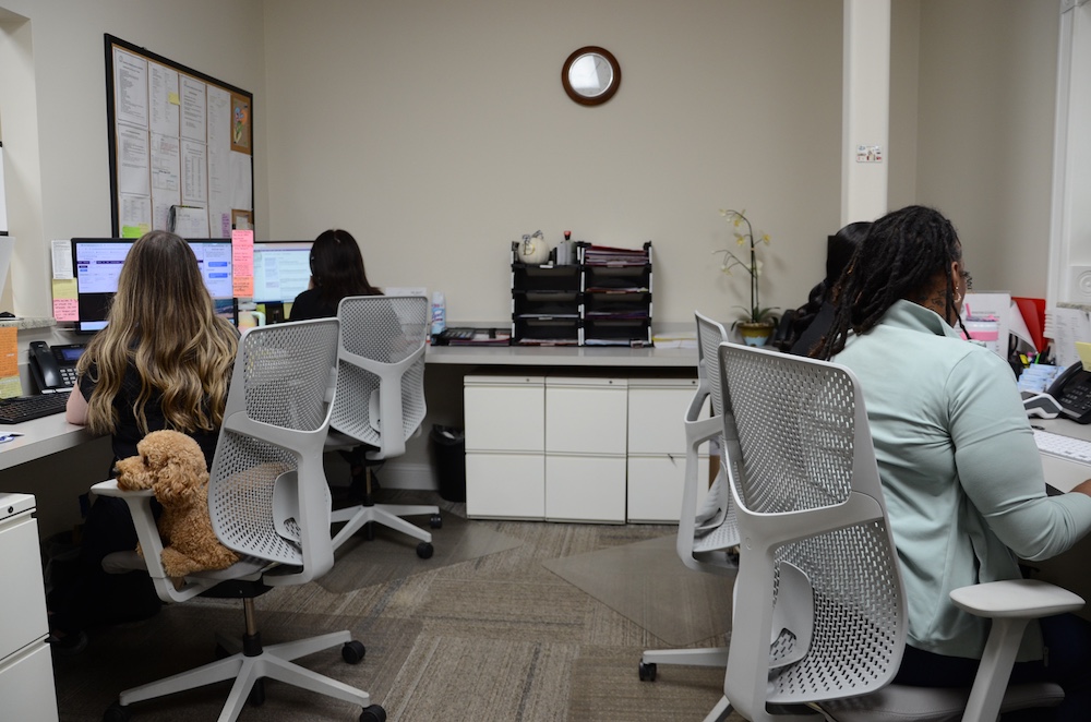 a woman sitting at a desk in a room