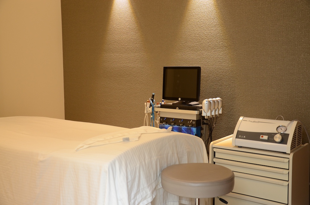 a bedroom with a bed and desk in a small room